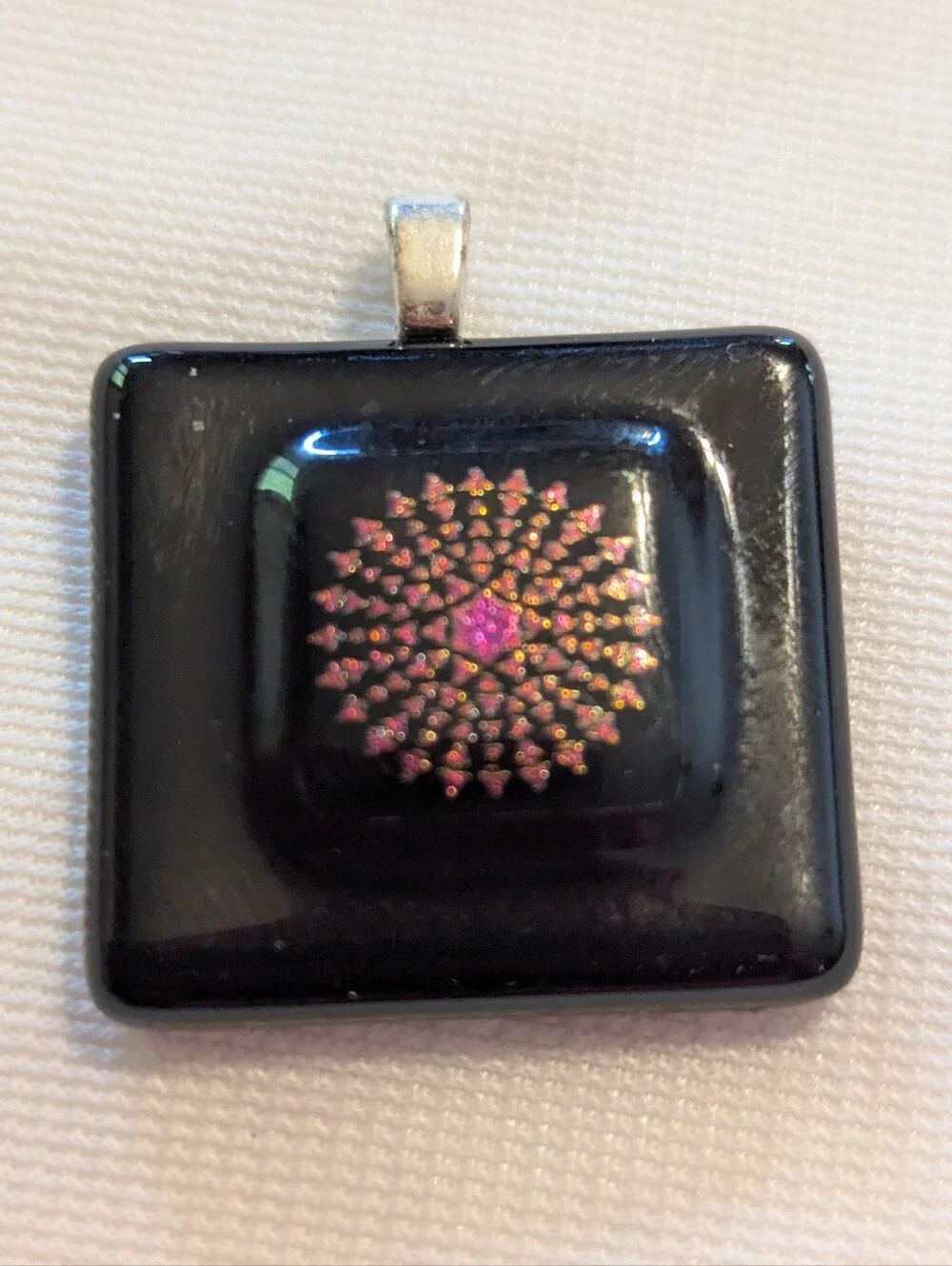 Black Pendant Featuring A Geometric Firework Pattern With Pink Center Handmade